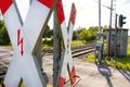 Guarded railroad crossing in the countryside with open barriers and cross of Saint Andrew. Royalty Free Stock Photo