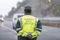 Guardia Civil officer next to a speed control monitors traffic