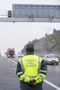 Guardia Civil officer next to a speed control monitors traffic Royalty Free Stock Photo