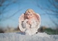 Guardian angel on blue sky background. Religion and faith concept. Winter time.