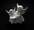 Guardian angel on a dark background two angels are reading a book Royalty Free Stock Photo