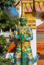 Guardian of the Buddha nio or dvarapala standing at the entrance of Buddhist temple in Thailand wat