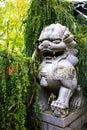 Guardian of the Garden Stone Lion Statue Amidst Verdant Foliage Royalty Free Stock Photo