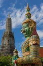 Guardian statue with the Temple of Dawn background, Thailand