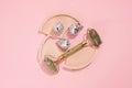 Guasha green natural gemstone face roller on pink background. Anti aging self care tool.