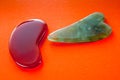 Guasha scrapers for body massage according to the ancient method shot on a bright red background