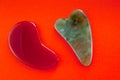 Guasha scrapers for body massage according to the ancient method shot on a bright red background