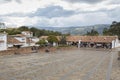 Guatavita colombian town main square with blue mountains and white clouds at background