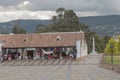 Guatavita gift shops with colonial architecture located in main square with andean mountains at background