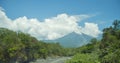 Inactive Volcano de Aqua with clouds among forest in Antigua, Guatemala