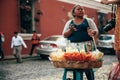 GUATEMALA - DECEMBER 28: photographer woman buys from a lady selling fruit on the street, December 28, 2018 in Antigua Guatemala,