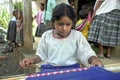 Guatemalan Indian girl is working on loom