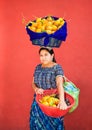 Guatemalan woman carries fruit in a baskets at her head and hand Royalty Free Stock Photo