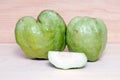 Guava fruit and half piece on wood background Royalty Free Stock Photo