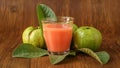 Guava fruit with leaves isolated on the wooden background Royalty Free Stock Photo