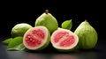 Guava fruits on black background. Whole and halves. Green peel, red flesh. Psidium guajava. Exotic tropical fruit