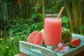 Guava smoothie in glass with bamboo drinking straw