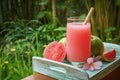 Guava smoothie in glass with bamboo drinking straw