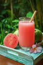 Guava smoothie in glass with bamboo drinking straw