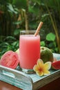 Guava smoothie in glass with bamboo drinking straw