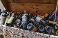 2019-08-14, Gubbio, Italy. Trunk with ancient wine bottles on local flea market