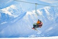 Gudauri, Georgia - 25th march, 2022: Elderly adventurous caucasian couple in ski chair lift together retired in winter ski resort