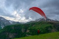 Gudauri, Kazbegi, Georgia: people paragliding through the Devils Valley in the Caucasus mountains. In the background the colorful