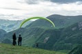 Gudauri, Kazbegi, Georgia: people paragliding through the Devils Valley in the Caucasus mountains. In the background the colorful