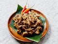 Gudeg, traditional Indonesian food, on a wooden plate and banana leaf