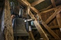 Gudow, Germany, November 13, 2020: Inside the old church tower from wooden construction with hanging bells and chiming drive Royalty Free Stock Photo