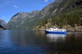 Scenic view of an EPOS boat on a Norwegian fjord voyage in sunshine. Royalty Free Stock Photo