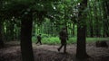 Guerilla partisan warriors walking in forest ambush carrying their guns.