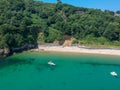 Guernsey small beach with sea, cliffs and little boat Royalty Free Stock Photo