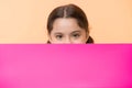 Guess what. Girl kid peeking out pink blank surface copy space. Advertisement concept. Child cute girl brunette looking