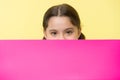 Guess what. Girl kid peeking out pink blank surface copy space. Advertisement concept. Child cute girl brunette looking