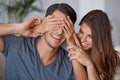 Guess what I got you. a young woman covering her husbands eyes for a surprise. Royalty Free Stock Photo