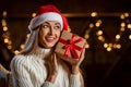 Happy Woman Shaking Christmas Present At Home Royalty Free Stock Photo