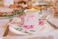 Guest card with pink flowers on the Banquet wedding table Royalty Free Stock Photo