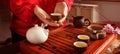 Guest holding cup of freshly brewed tea during traditional ceremony at table indoors, closeup. Banner design Royalty Free Stock Photo