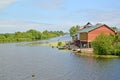 Guest houses with sheds on the river bank of Deyma. Polessk, Kaliningrad region Royalty Free Stock Photo