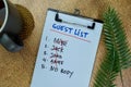 Guest List write on a paperwork and supported by additional services isolated on Wooden Table