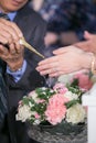 Guest pouring water with bride and groom hands in water relaunch Royalty Free Stock Photo