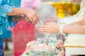 Guest pouring water with bride and groom hands in water relaunch Royalty Free Stock Photo