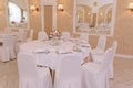 Guest tables with bouquet in rich decorated wedding banquet room Royalty Free Stock Photo