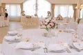 Guest tables with bouquet in rich decorated wedding banquet room Royalty Free Stock Photo