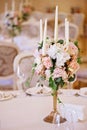 Guest tables with candlestick in rich decorated wedding banquet room Royalty Free Stock Photo