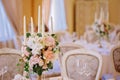 Guest tables with candlestick in rich decorated wedding banquet room Royalty Free Stock Photo