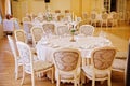 Guest tables with candlestick in rich decorated wedding banquet room Royalty Free Stock Photo