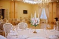 Guest tables with candlestick in rich decorated wedding banquet room Royalty Free Stock Photo