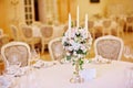 Guest tables with candlestick in rich decorated wedding banquet room Royalty Free Stock Photo